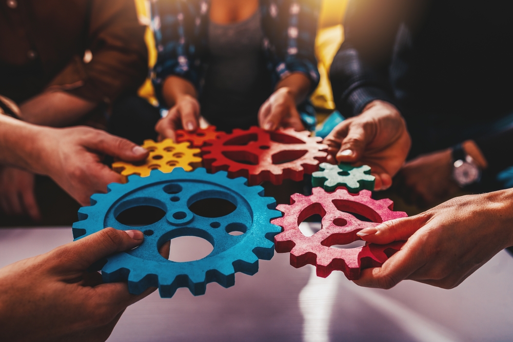 business,team,work,together,and,combine,pieces,of,gears.,partnership